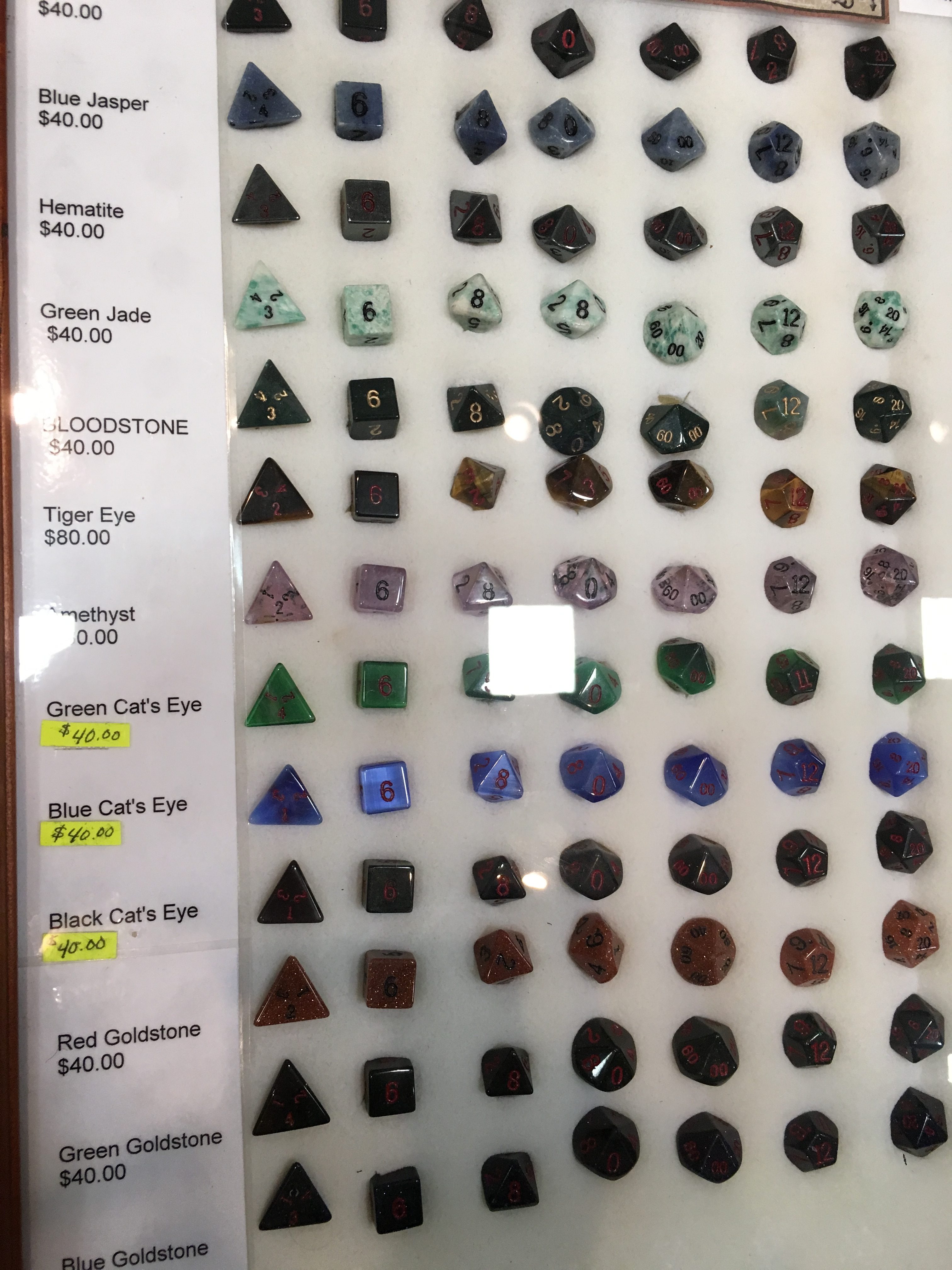A display case filled with gemstone dice